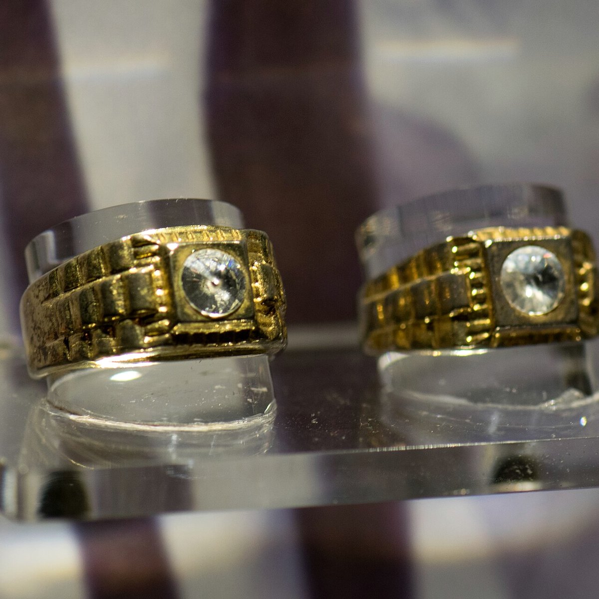 vintage diamond and gemstone estate rings and a signed brooch on white paper