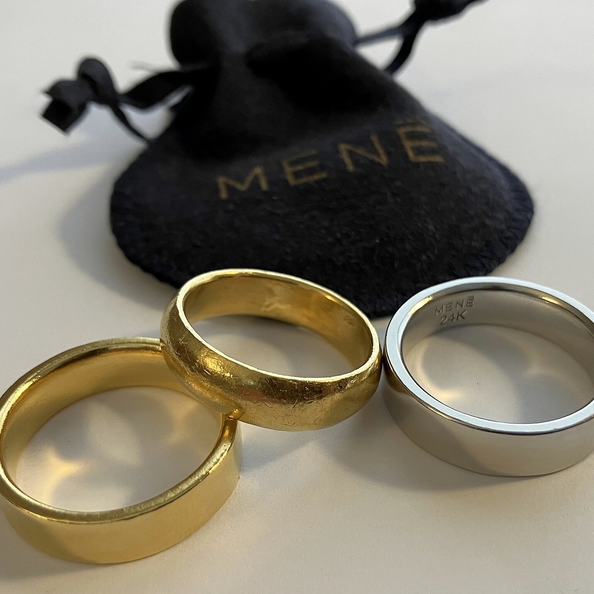 a tangle of broken gold chains, single earrings and bent rings on a scale
